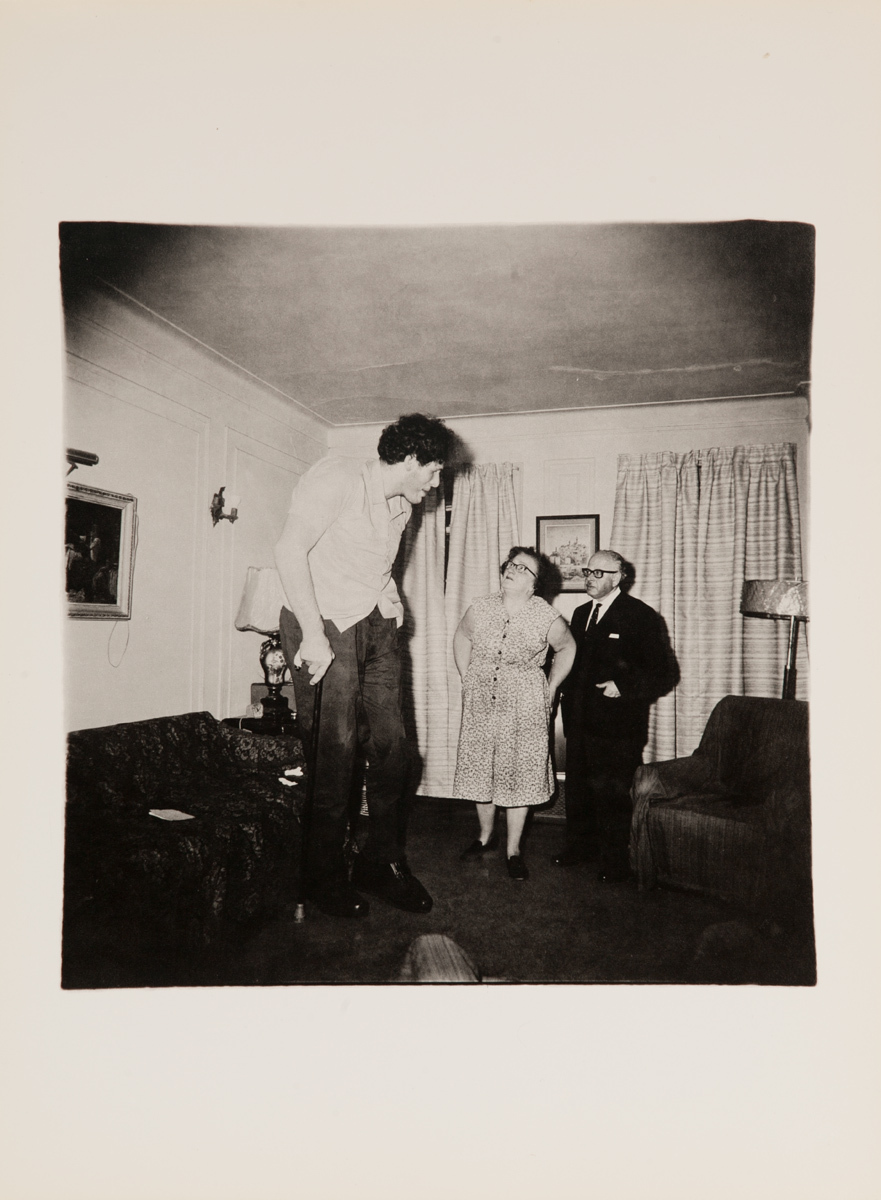 Jewish Giant at home with his parents in the Bronx, New York, 1970